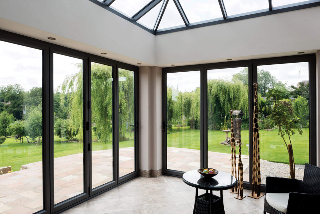 Black Bi Fold Door Installation On Modern Conservatory
