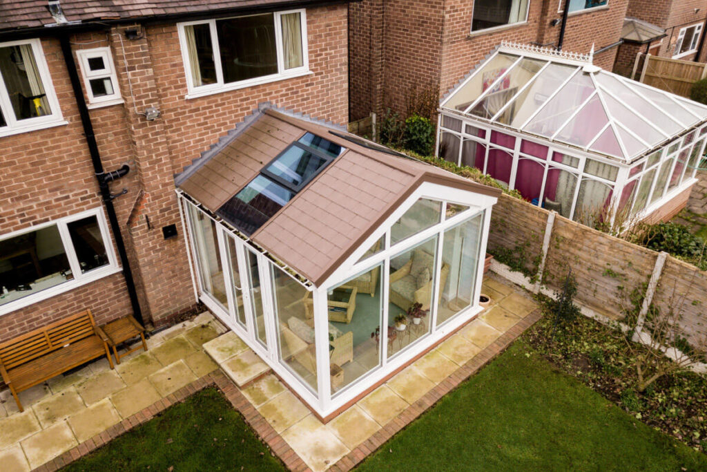 White Conservatory Installation On Brick Home